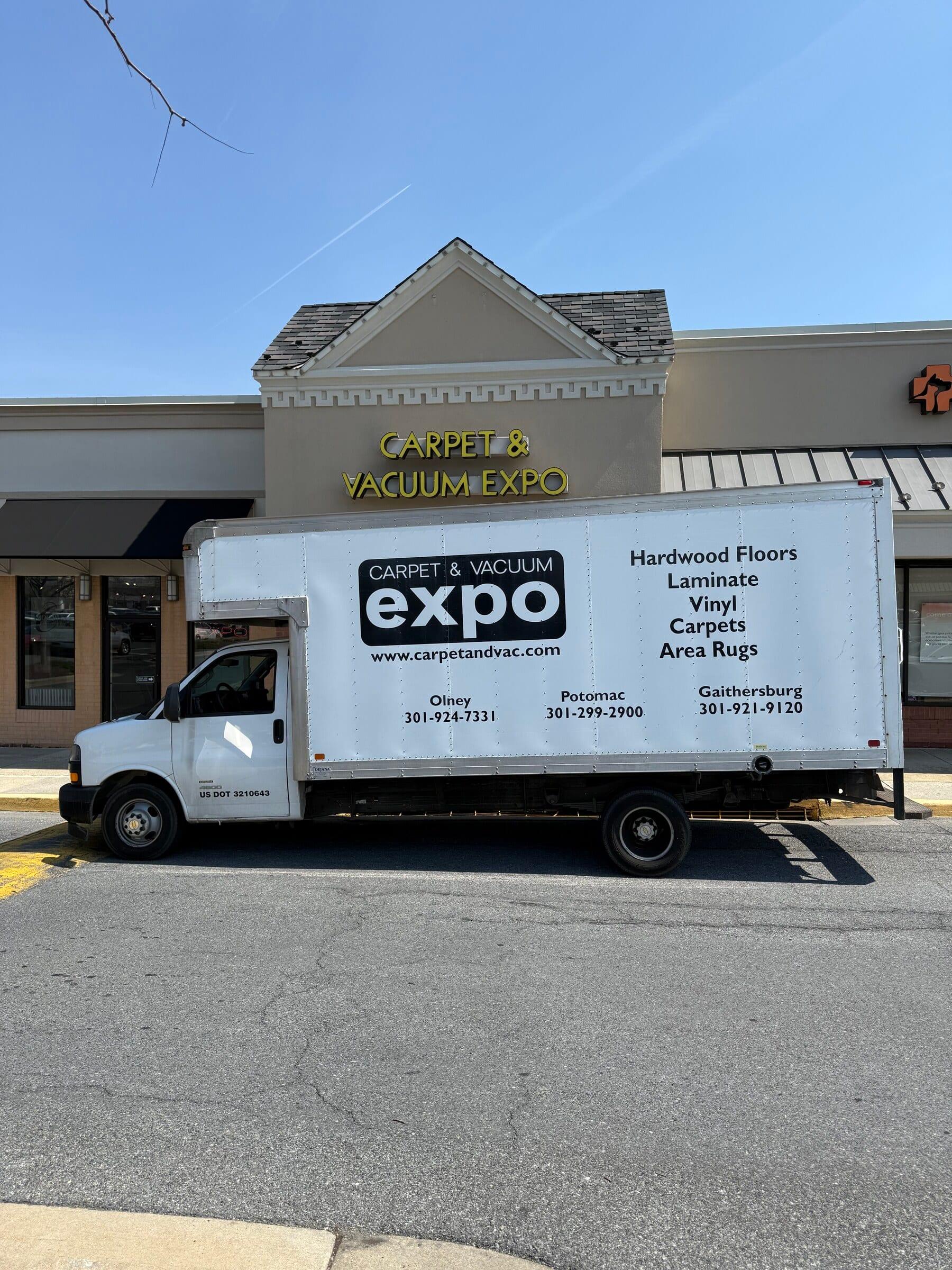 Carpet & Vacuum Expo box truck at the storefront.