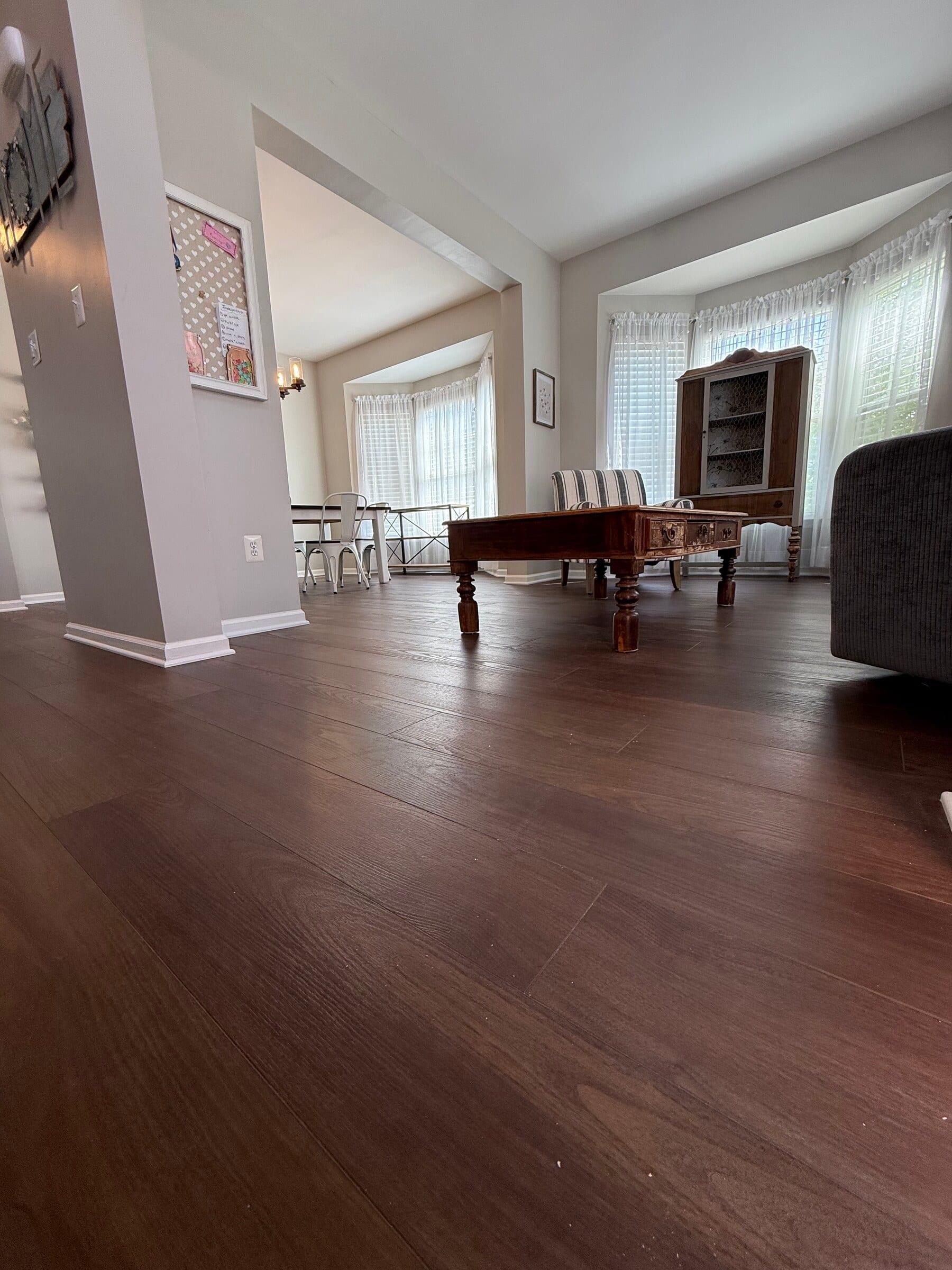 Dark hardwood flooring creates a continuous path through an open Montgomery County home.