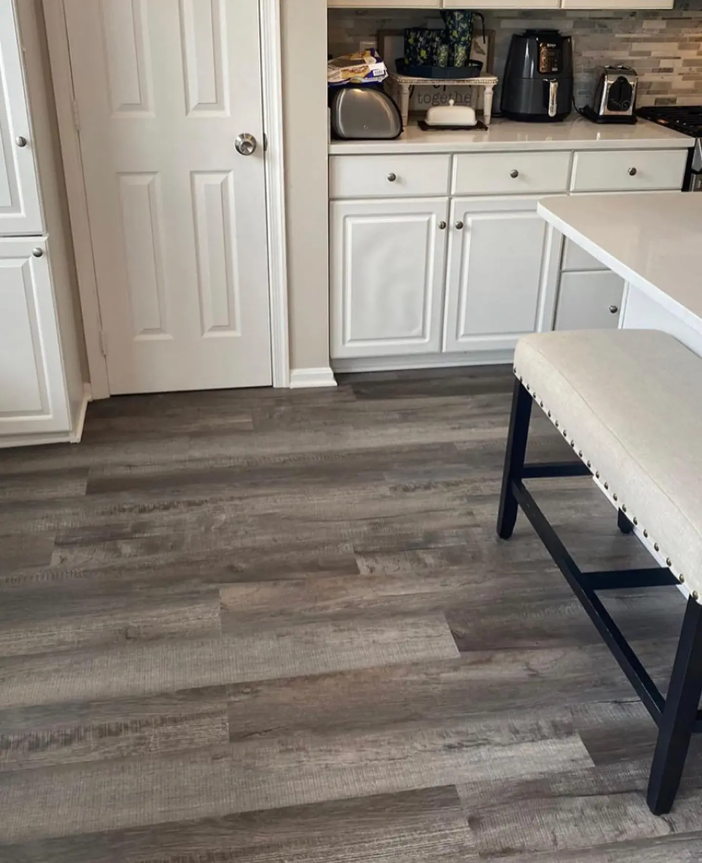 COREtec Galveston Oak flooring beside kitchen cabinetry