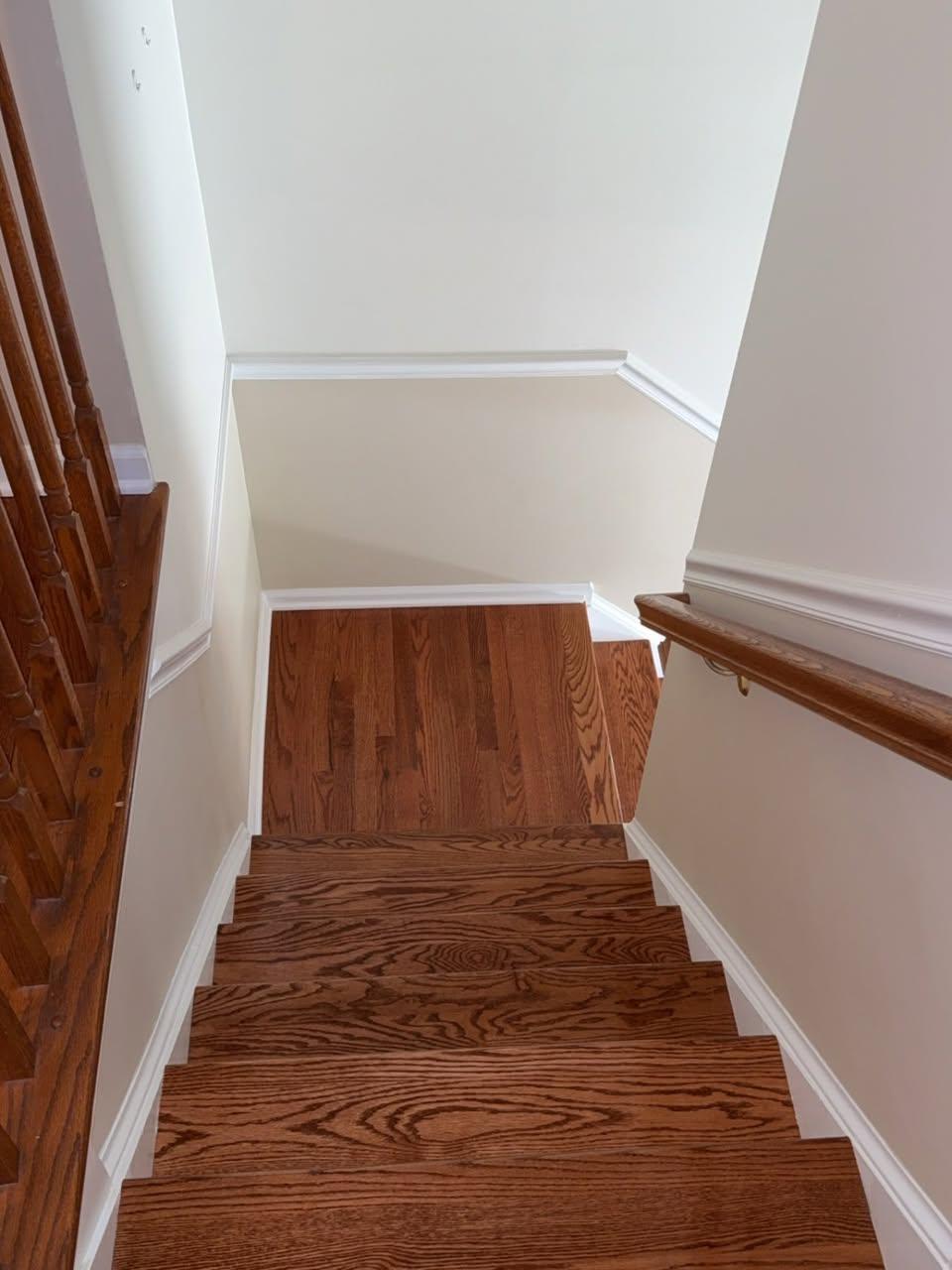 View down the hardwood stairs toward the wood landing