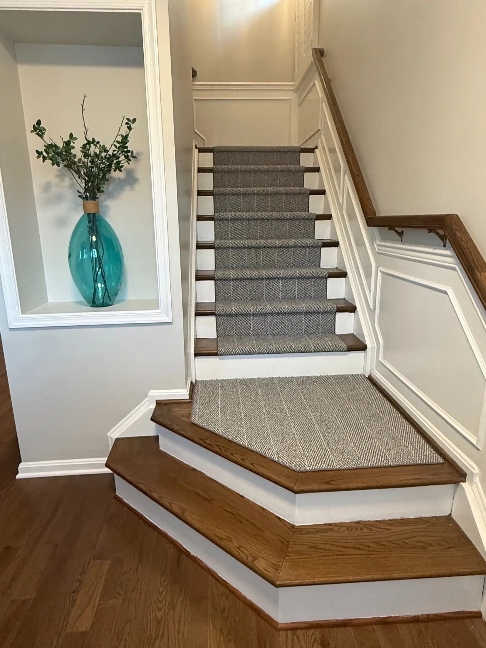 Gray nylon runner fitted across a stair landing and the adjoining steps