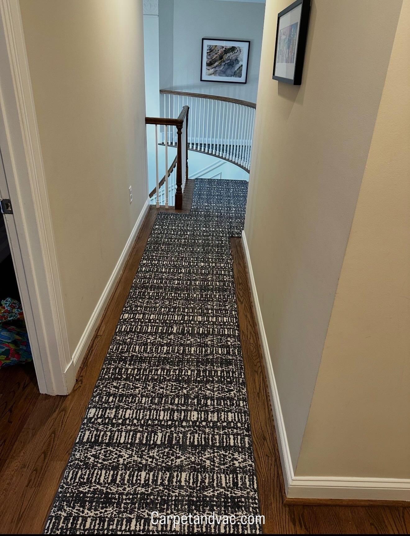 Hallway runner beside the curved stair railing