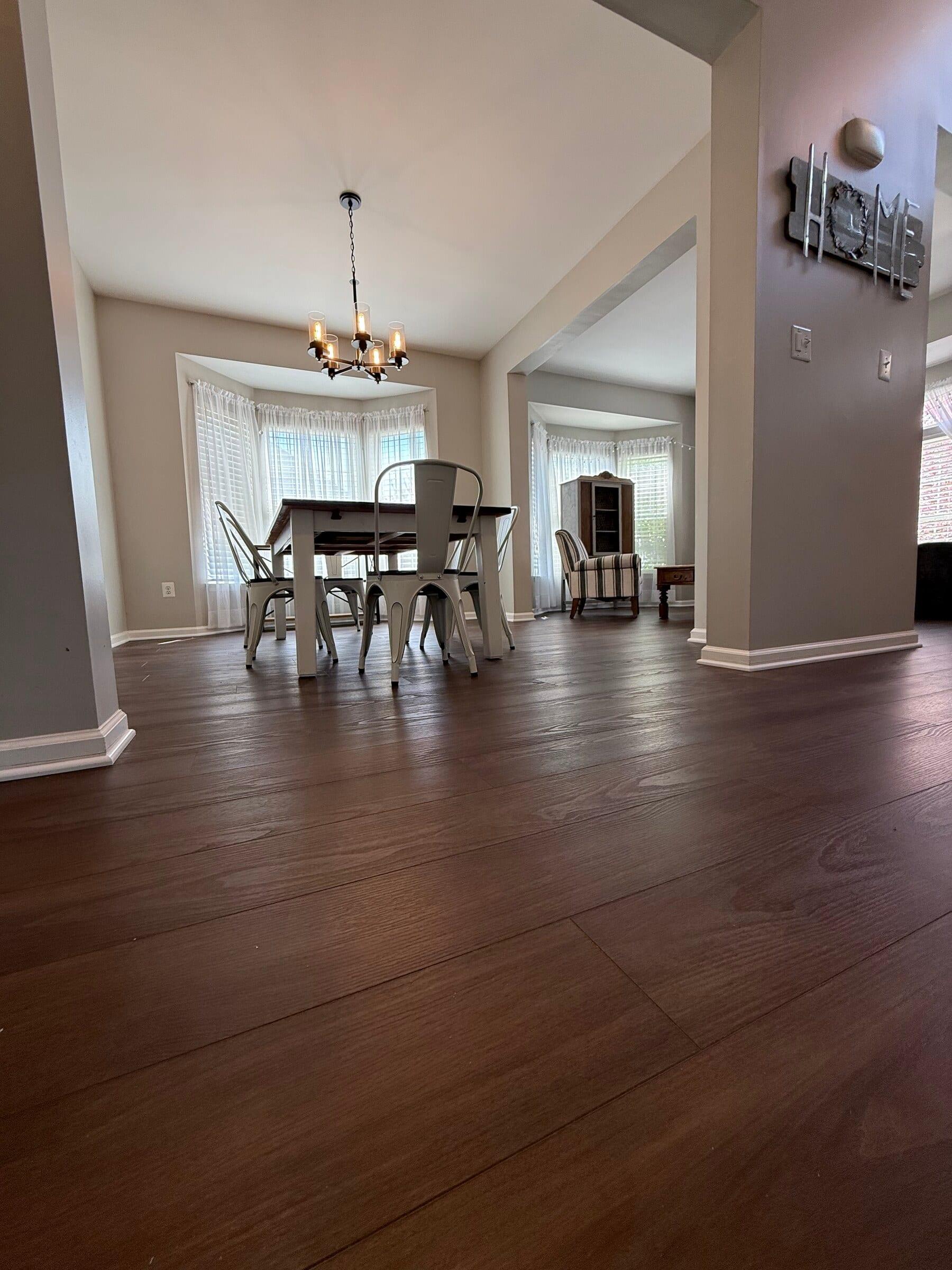 A finished lower-level dining room with wide-plank floor in a Montgomery County home.