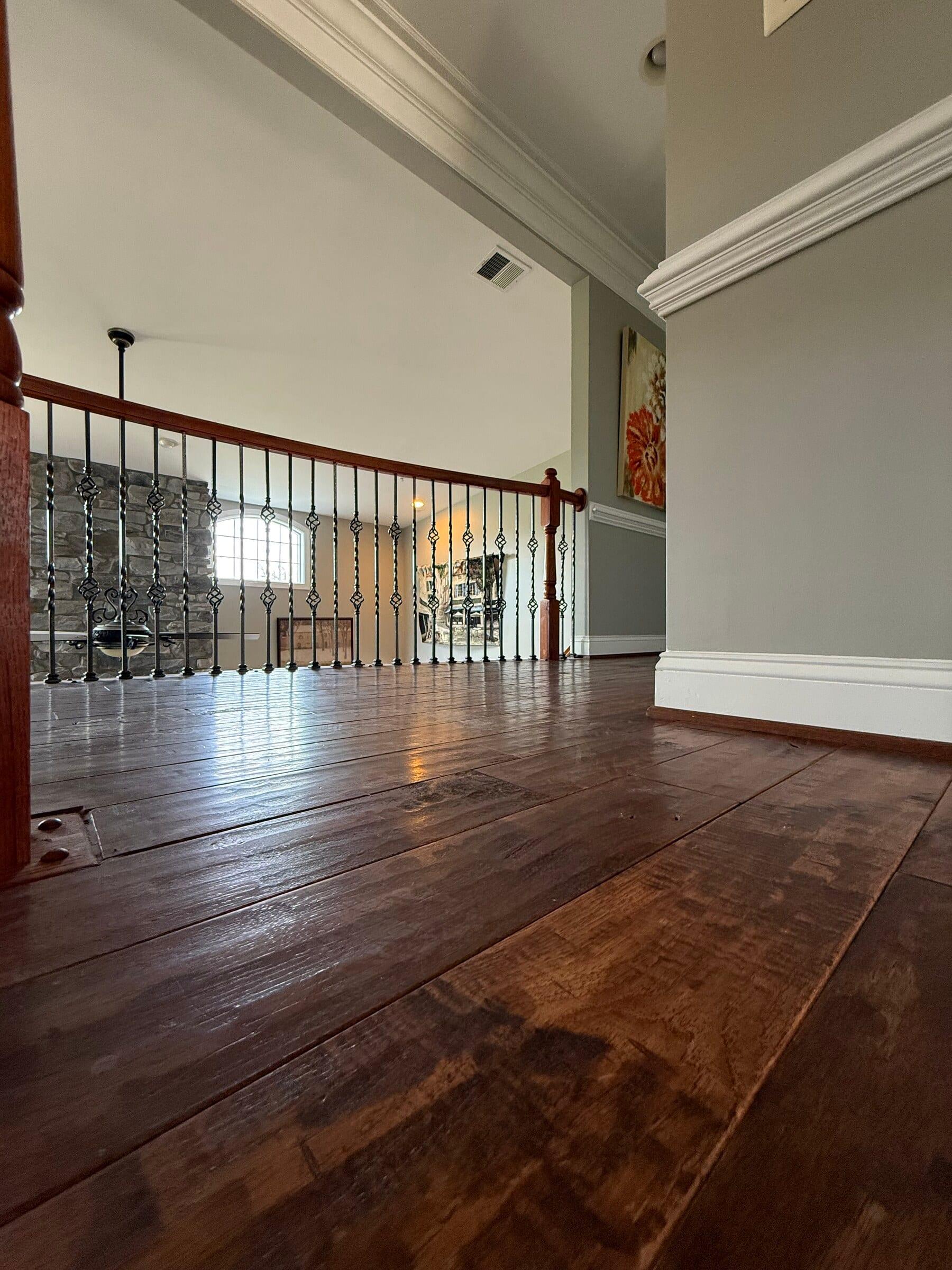 Wide-plank natural oak hardwood installed by Carpet & Vacuum Expo across a Montgomery County home.