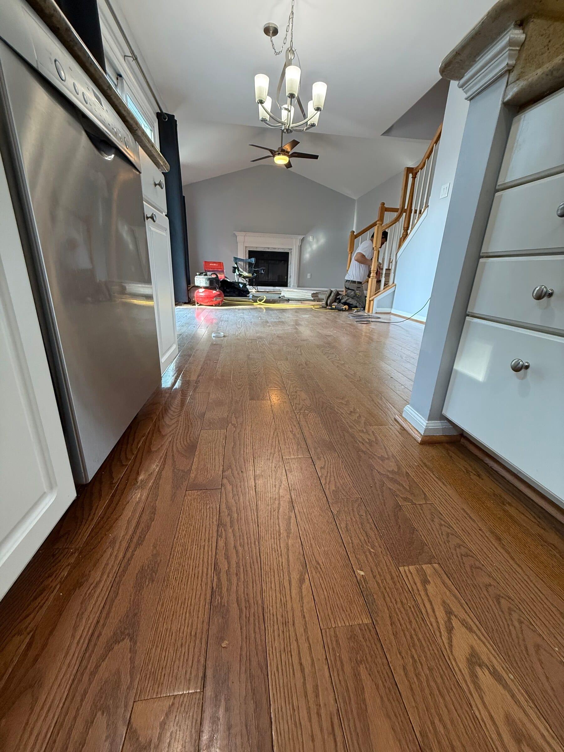 Before: kitchen and adjoining living space before the flooring work was complete