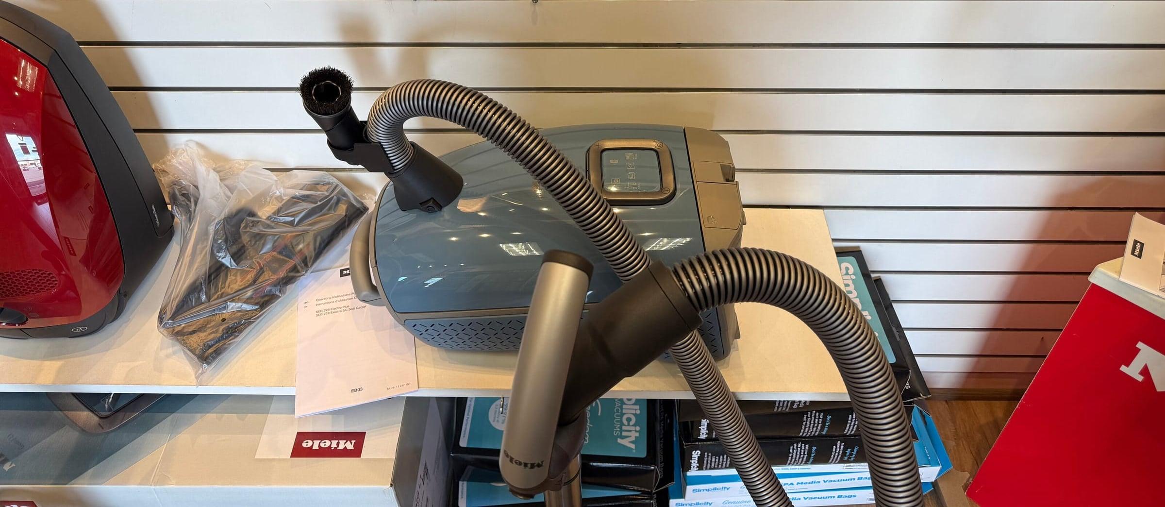 Miele canister vacuum on the showroom shelf