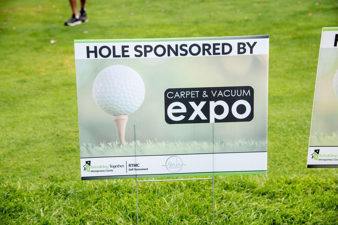 Carpet & Vacuum Expo hole sponsorship sign at the Rebuilding Together Montgomery County golf tournament