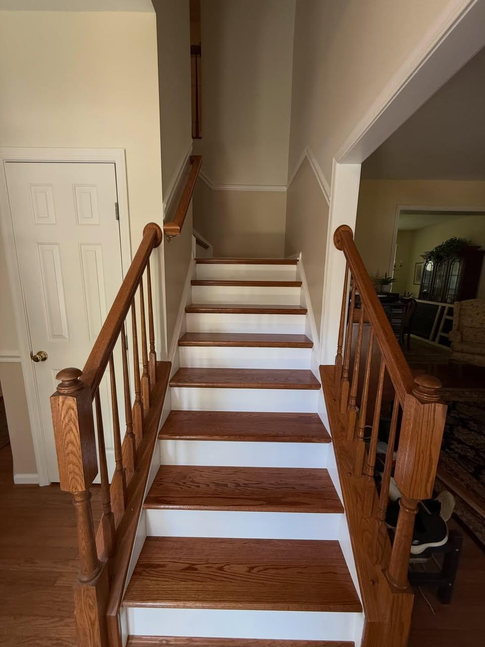 Hardwood stair treads with white risers and wood railings